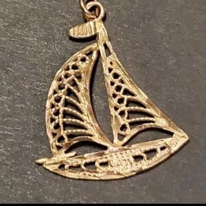 14k (stamped see pics) yellow gold Sailboat Pendant! This pendant has  alot of d